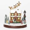 Santa and Reindeer over rooftop with lighted house and revolving train musical