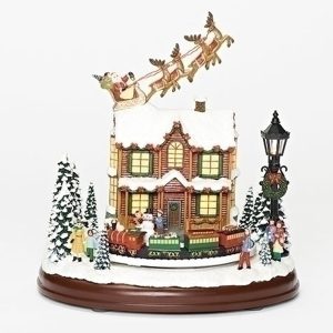 Santa and Reindeer over rooftop with lighted house and revolving train musical